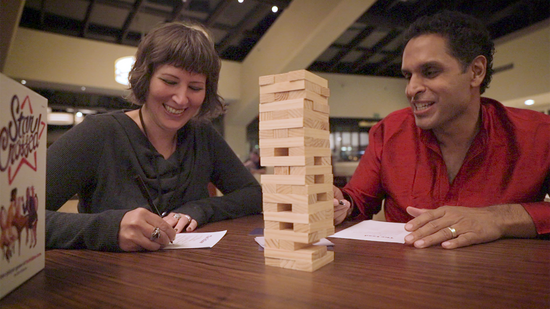 two people playing the game at a table